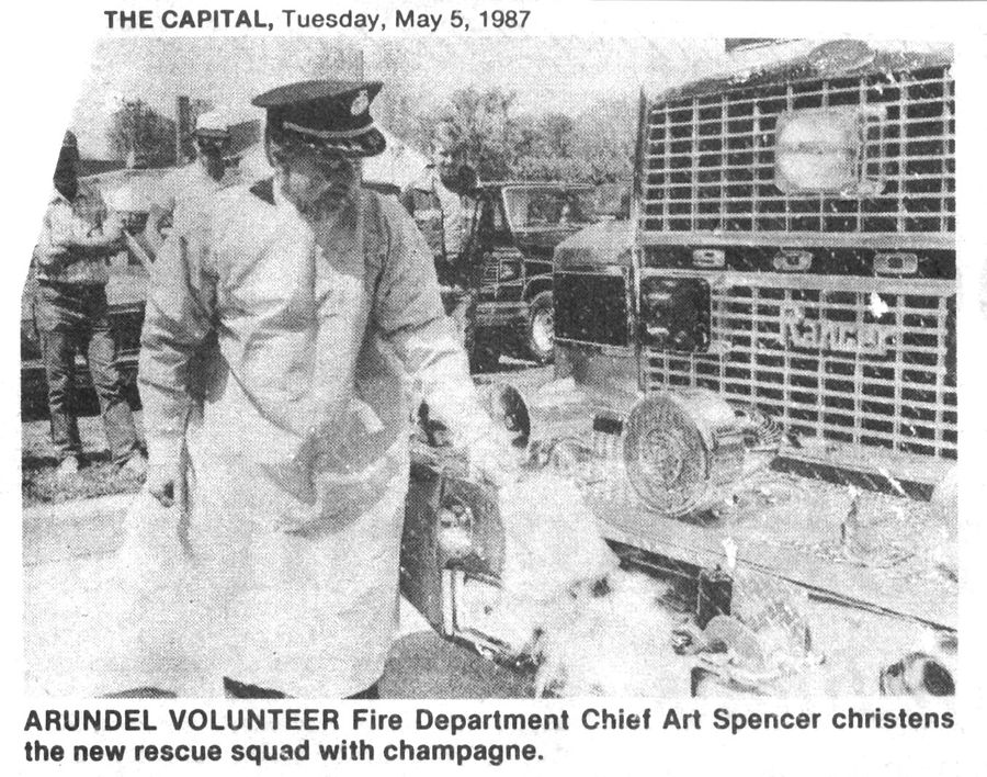 Chief Art Spencer christens the new rescue squad with champagne.