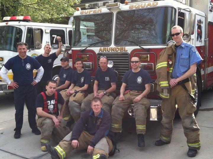 A squad crew posing together in front of the Super Squad