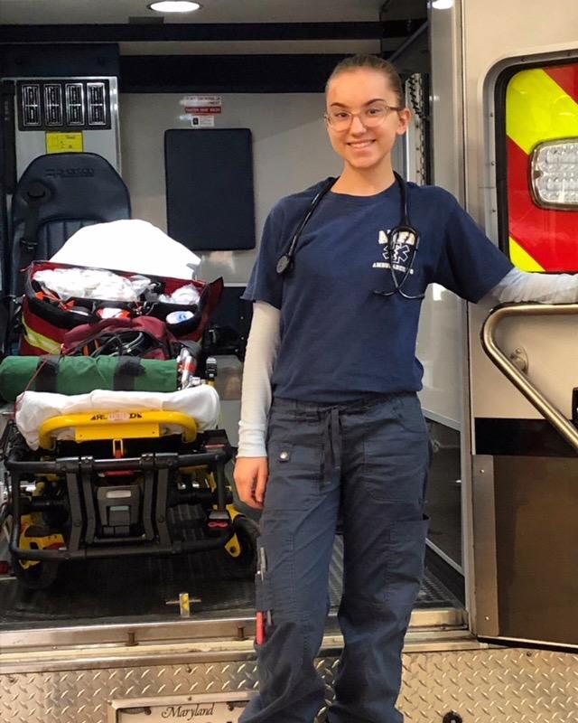 An AVFD EMS provider standing at the back of the ambulance